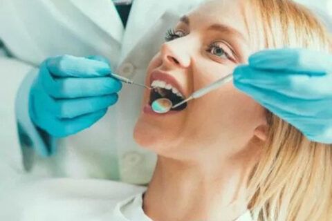 girl at the dentist getting a check up on her teeth